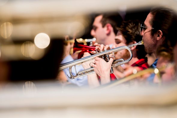 band members playing the trumpet outside