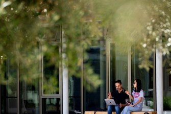 two students sit on a bench