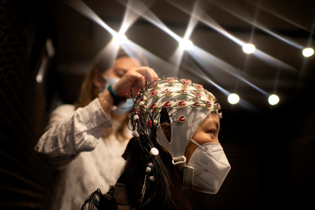 person wearing mask and head covering for research