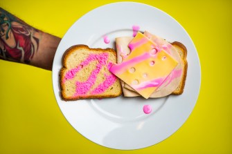 cheese and meat sandwich with pink sauce drizzled over top