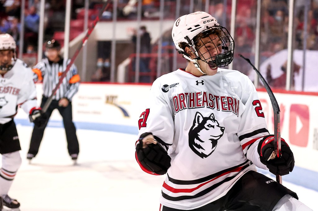 northeastern hockey player cheering on the ice