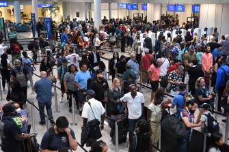 large lines of people waiting at an airport