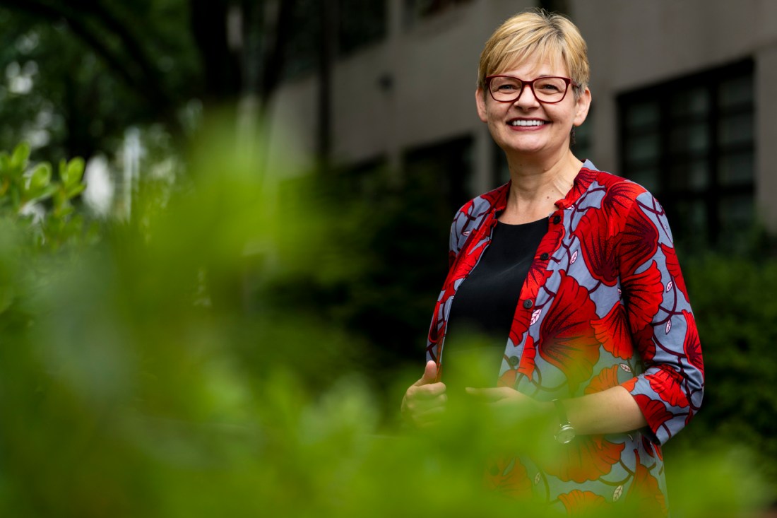 Portrait of Maria Ivanova, smiling, outside amongst greenery