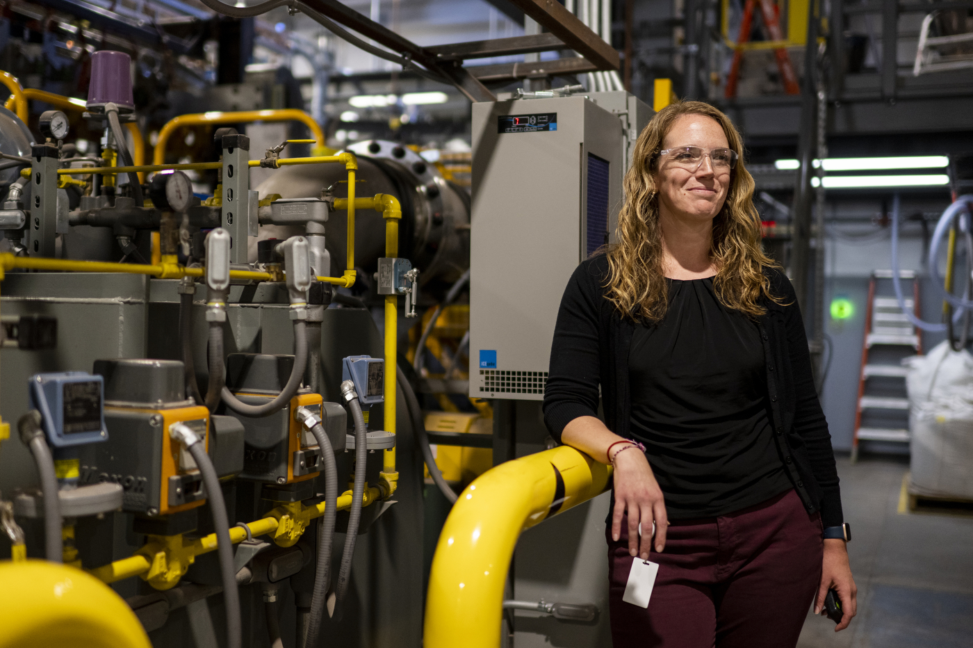 Kara Gibson posing by engineering equipment