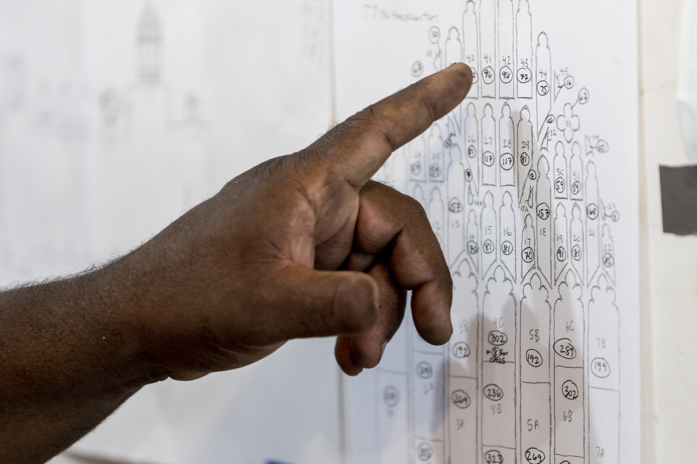 hand pointing to sketch of window plan