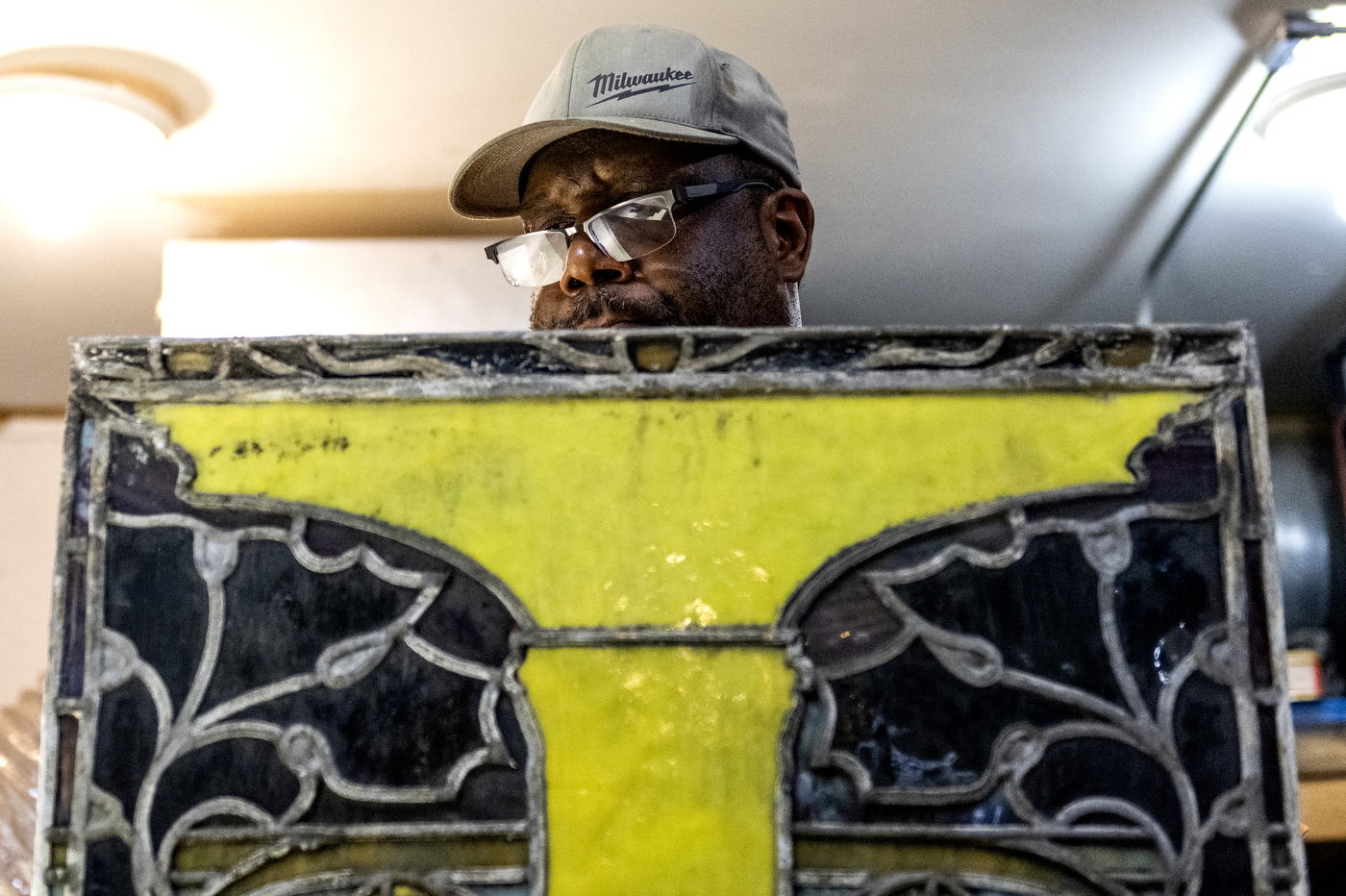 person restoring stained glass window