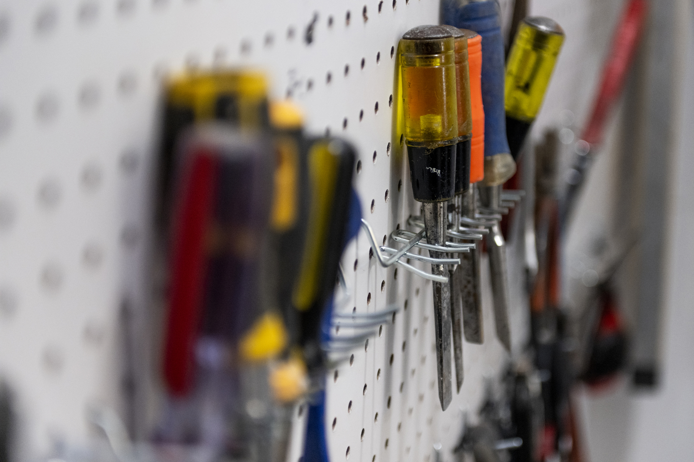 tools hanging on peg board