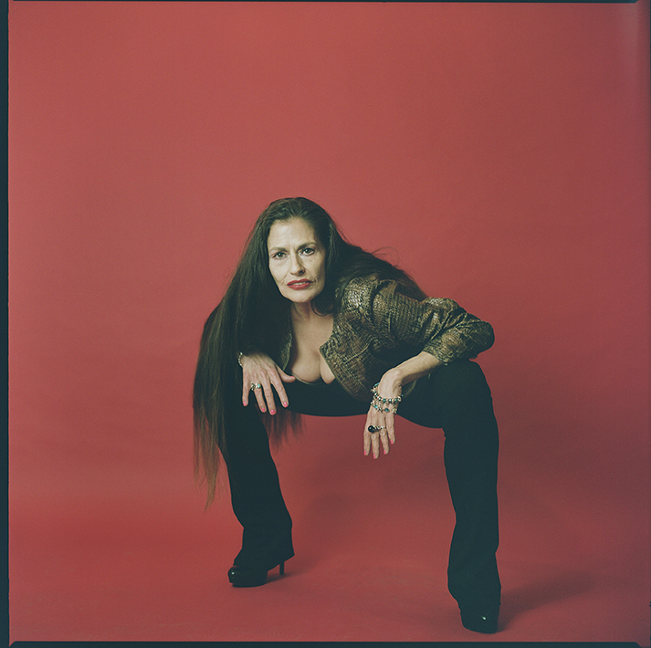 lena shkoda posing in front of a red background