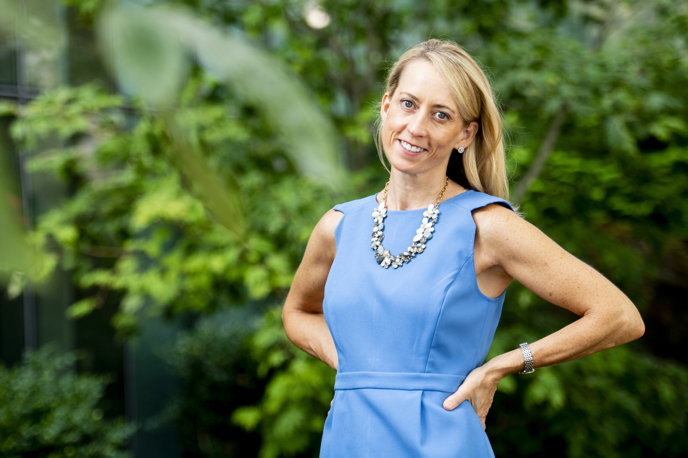 Nicole Laffan, standing in front of a verdant background