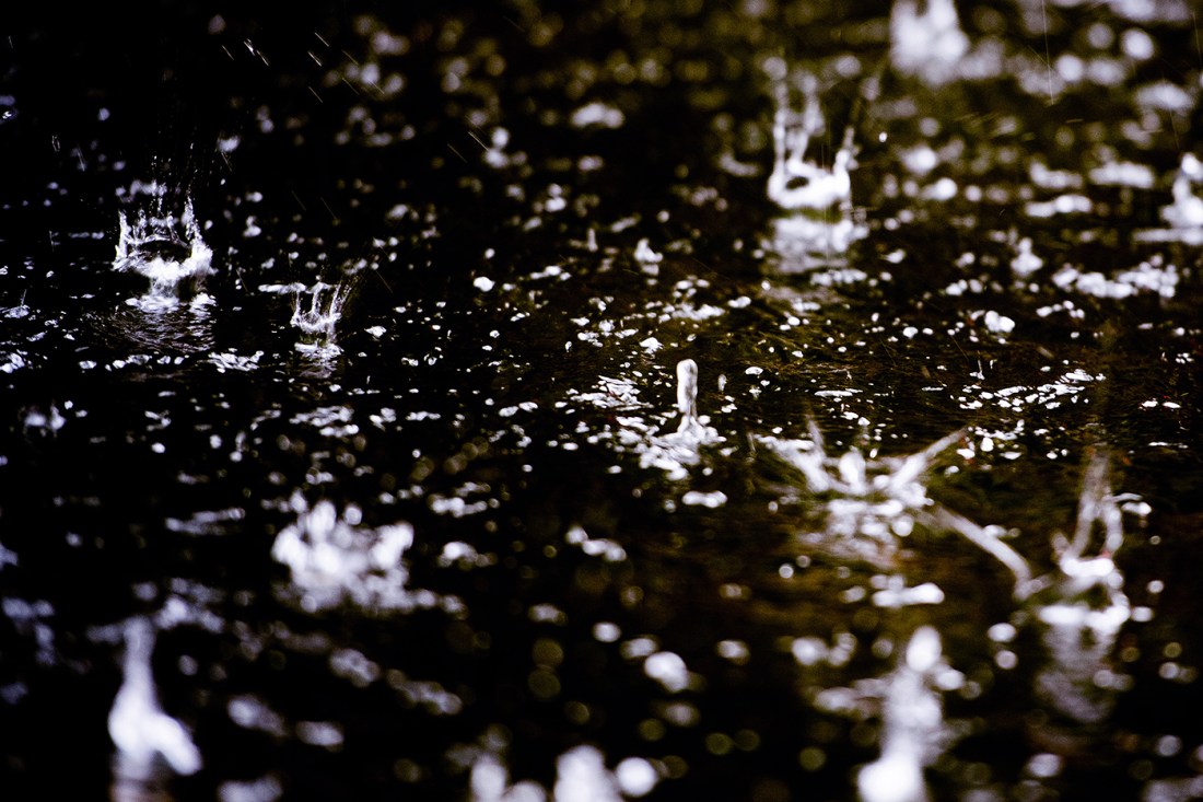 rain drops splashing on pavement