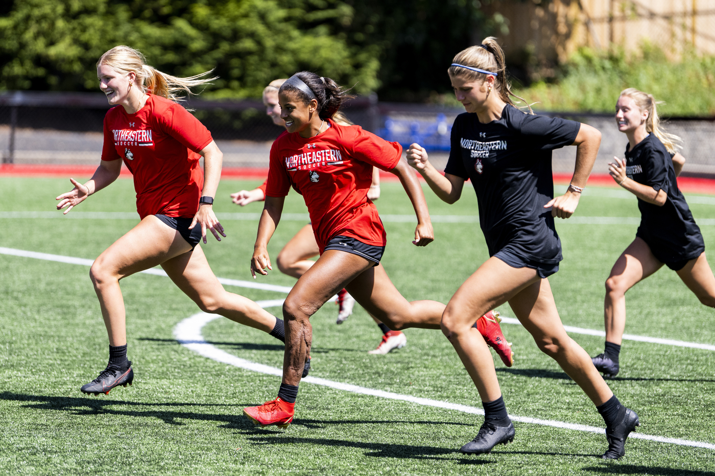 Katherine Marchesseault runs with teammates on a soccer field