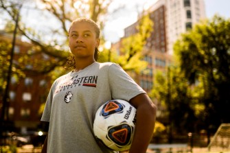 Katherine Marchesseault poses with a soccer ball under her arm