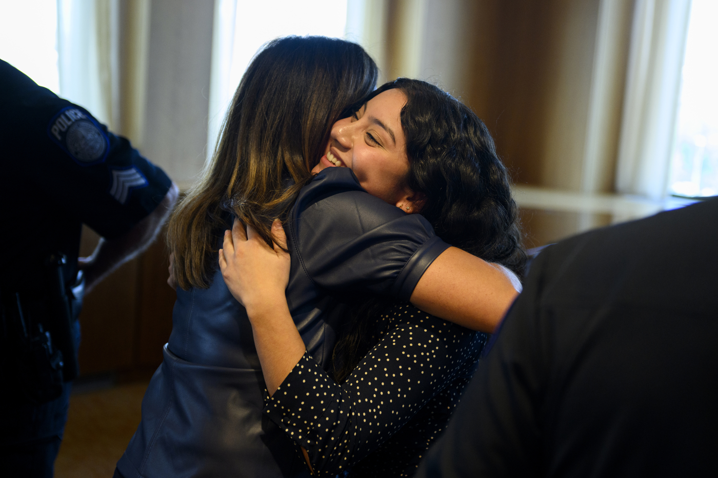 A person part of NUPD's police mentorship program is hugging someone. 