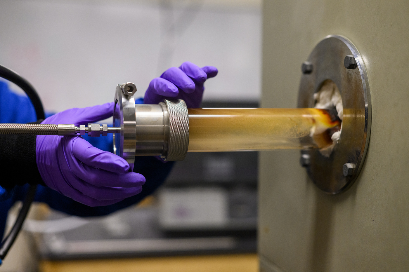 Purple gloved hands holding a silicon nanowire