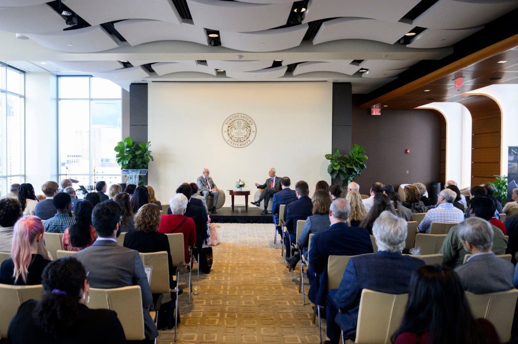 Seated audience watches a chat