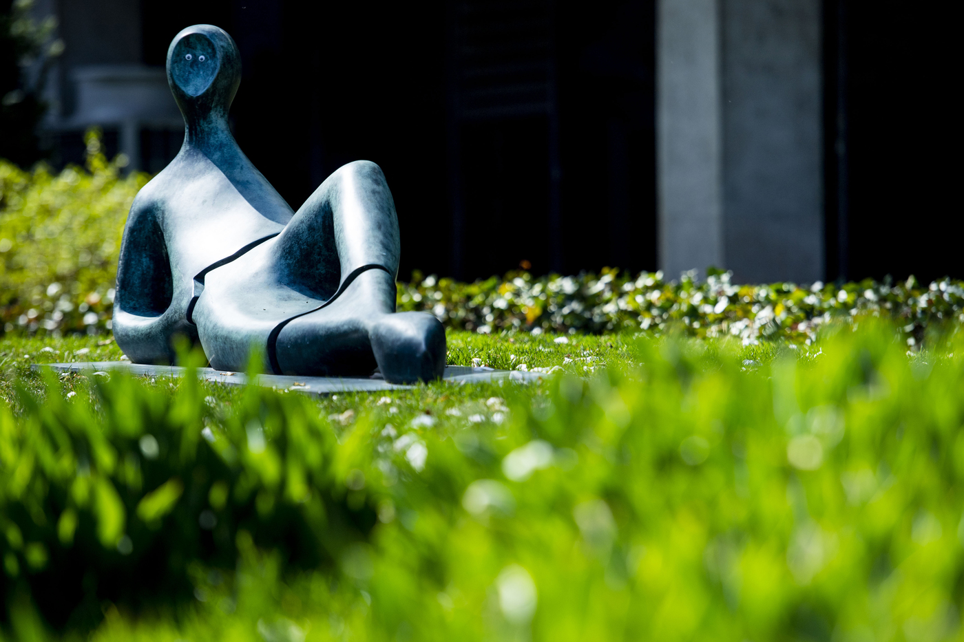 A grey statue is laying on the ground on Northeastern's Boston campus.