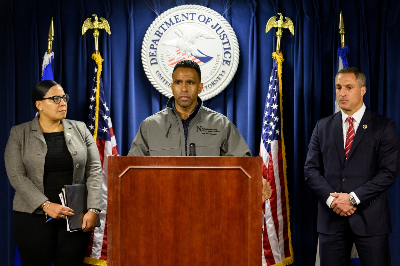 Michael David speaking in front of microphone at press conference