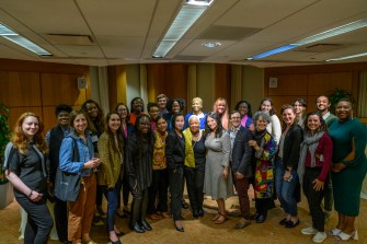 A large group of students, faculty and staff pose for a group photo