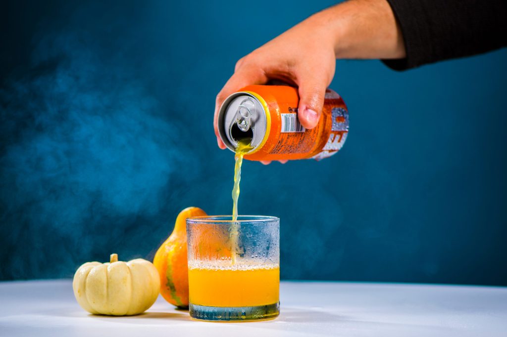 hand pouring hard cider into a glass