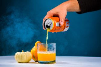 hand pouring hard cider into a glass