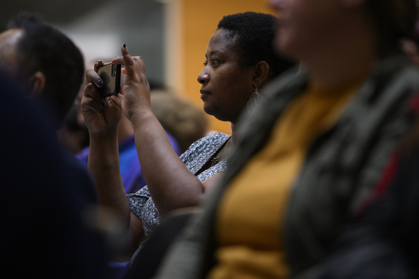 People stand together while clapping. 