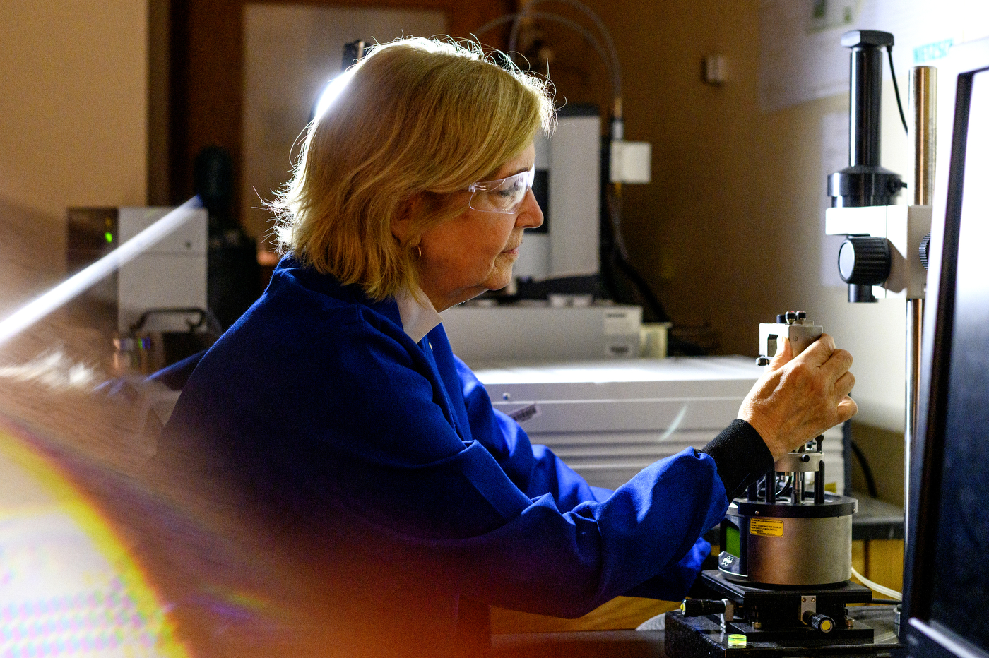 professor laura lewis in lab coat and glasses