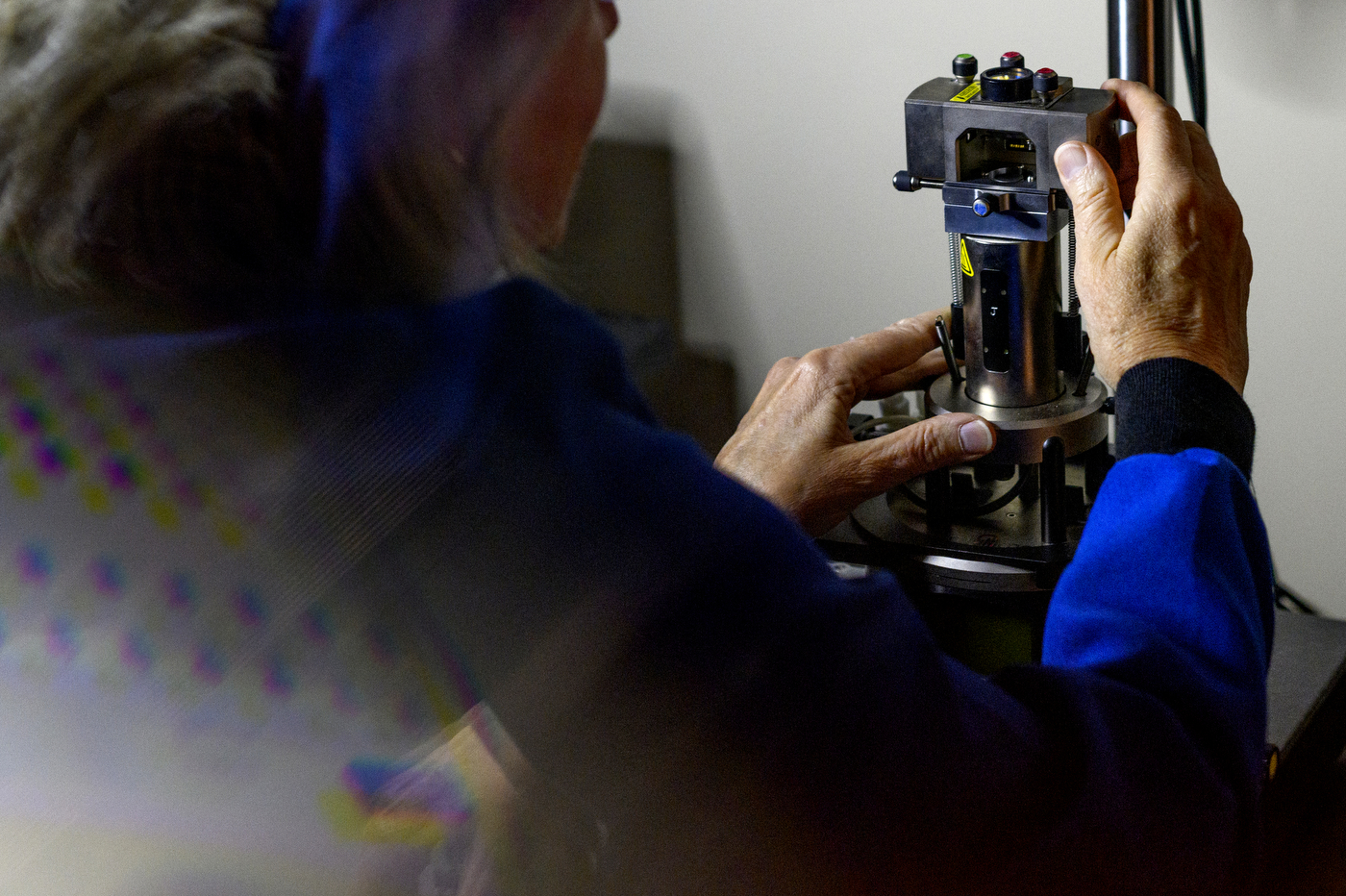 professor laura lewis holding research equipment