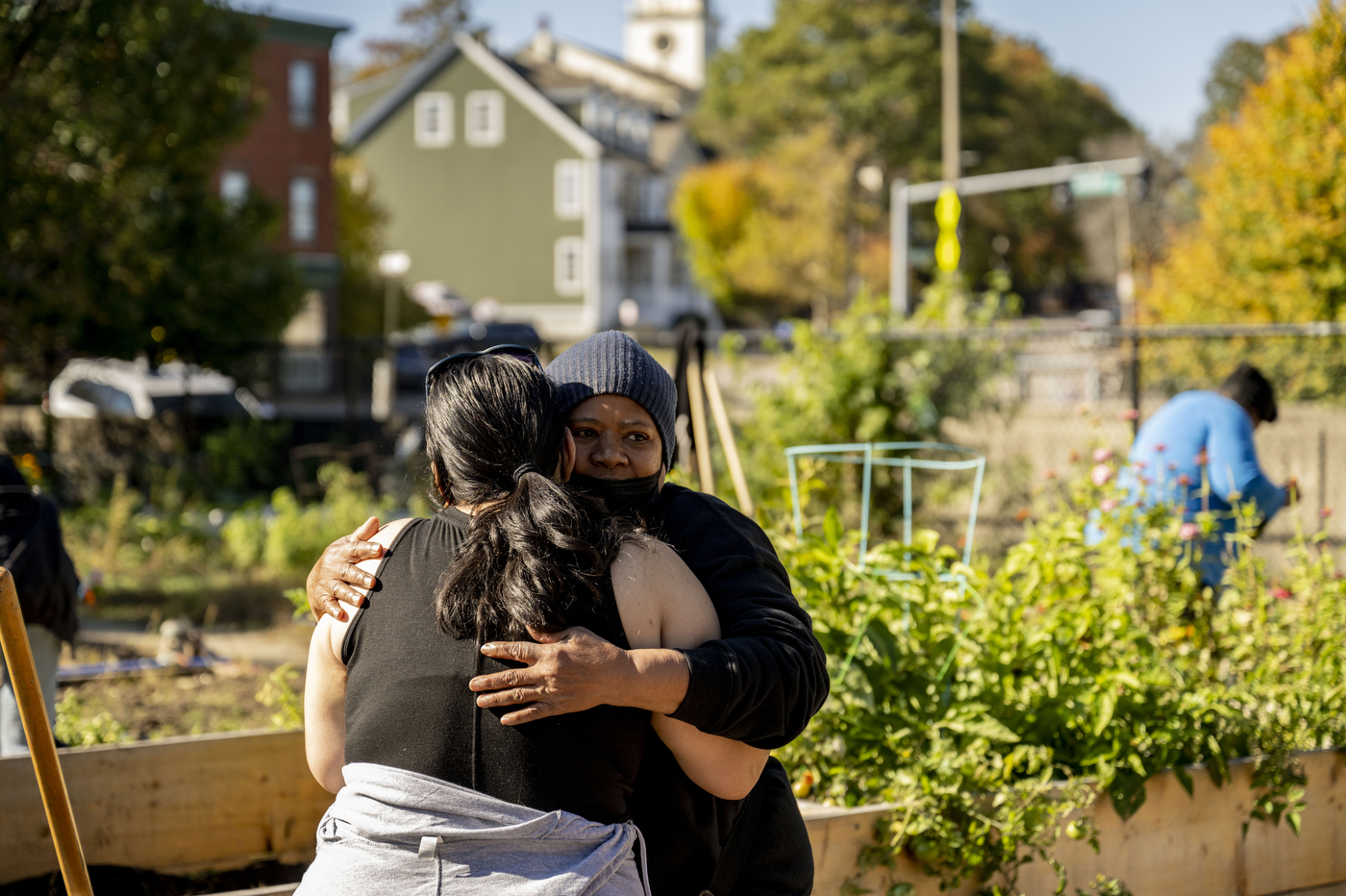 two women hugging in a garden