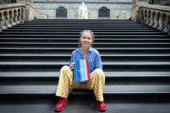 greta thunberg posing with new book