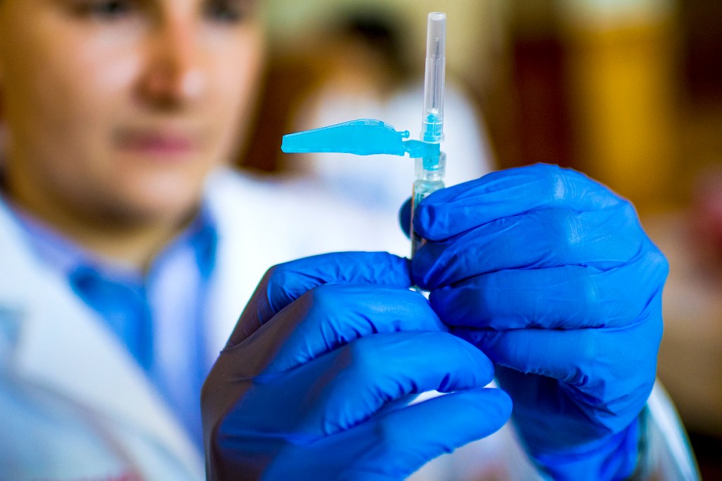 medical professional holding a syringe