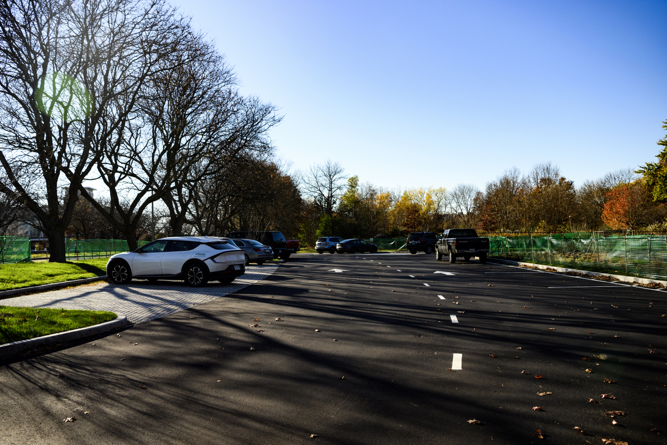 parking lot with a few cars parked on blacktop pavement