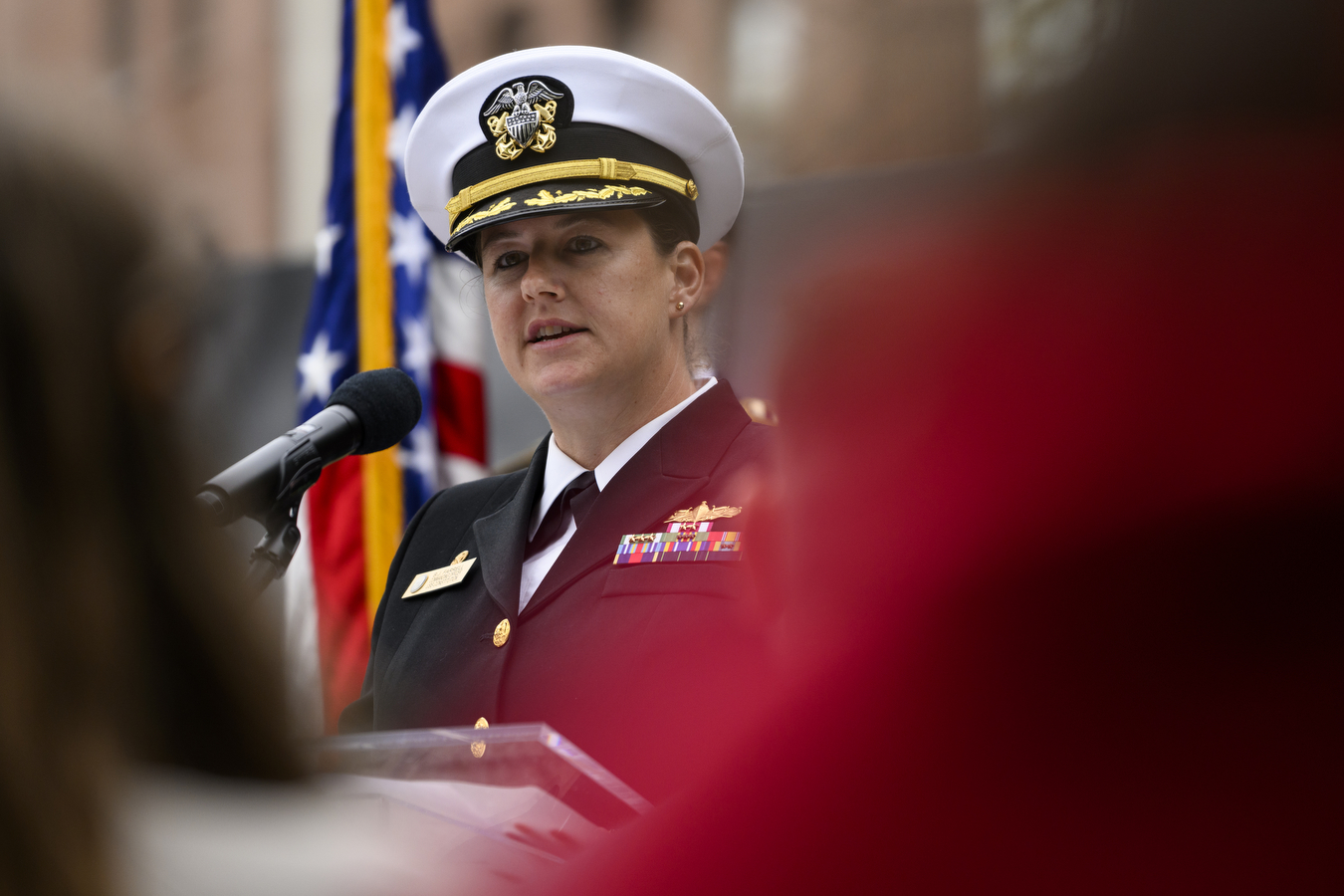 Billie J. Farrell, the first woman commander in the 225-year history of the USS Constitution, in military uniform speaking at a podium