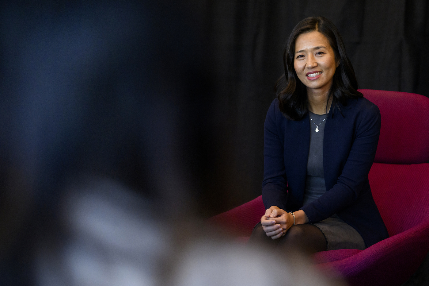 mayor michelle wu sitting in a chair and smiling