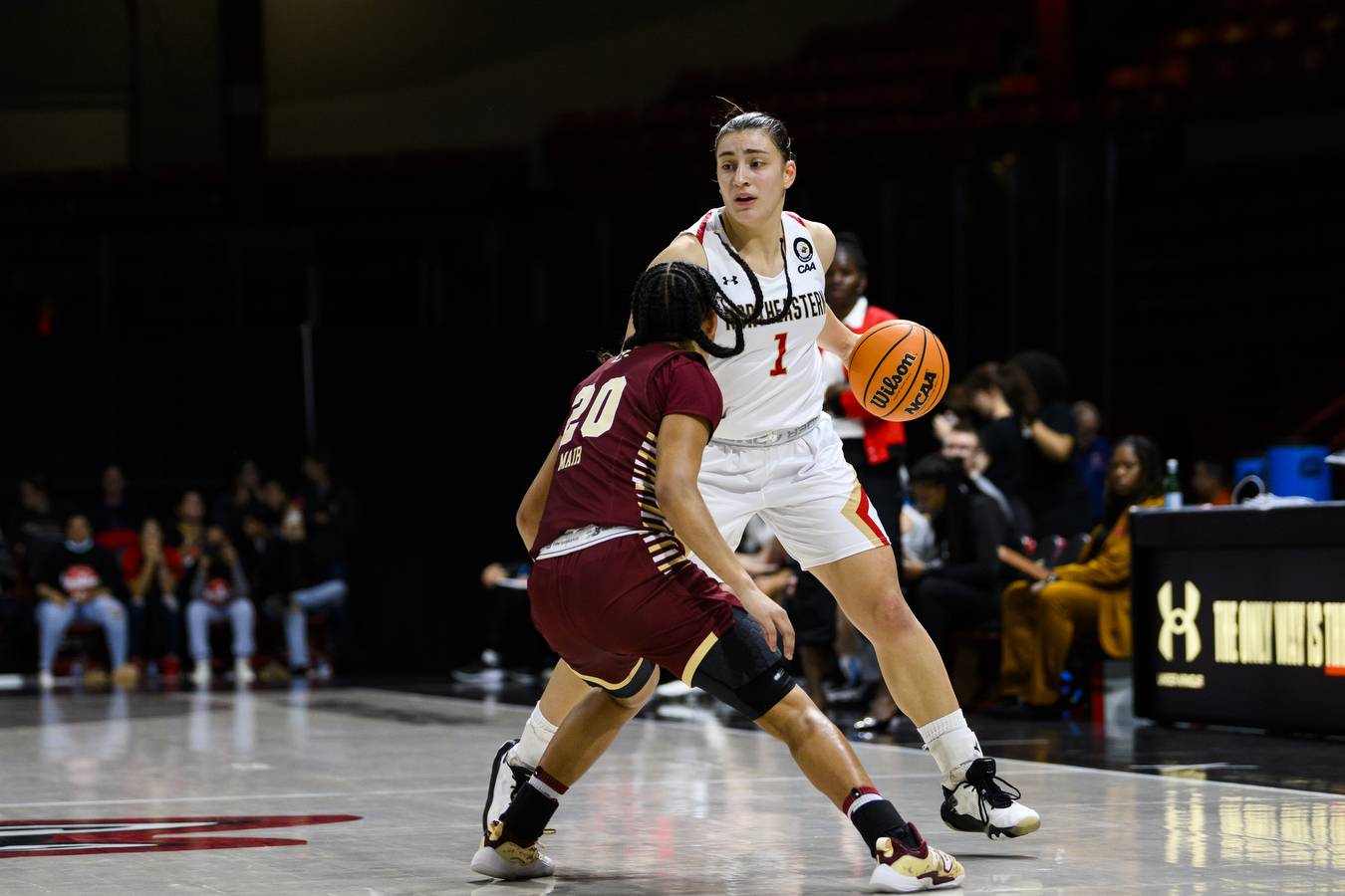 womans basketball player dribbles down court