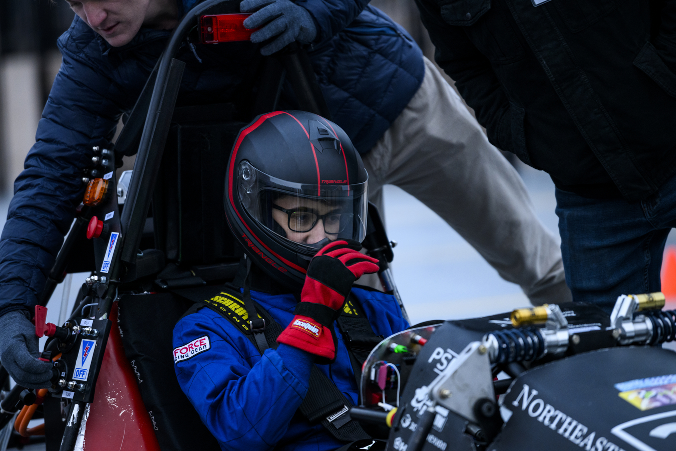 Person preparing to drive electric racing car