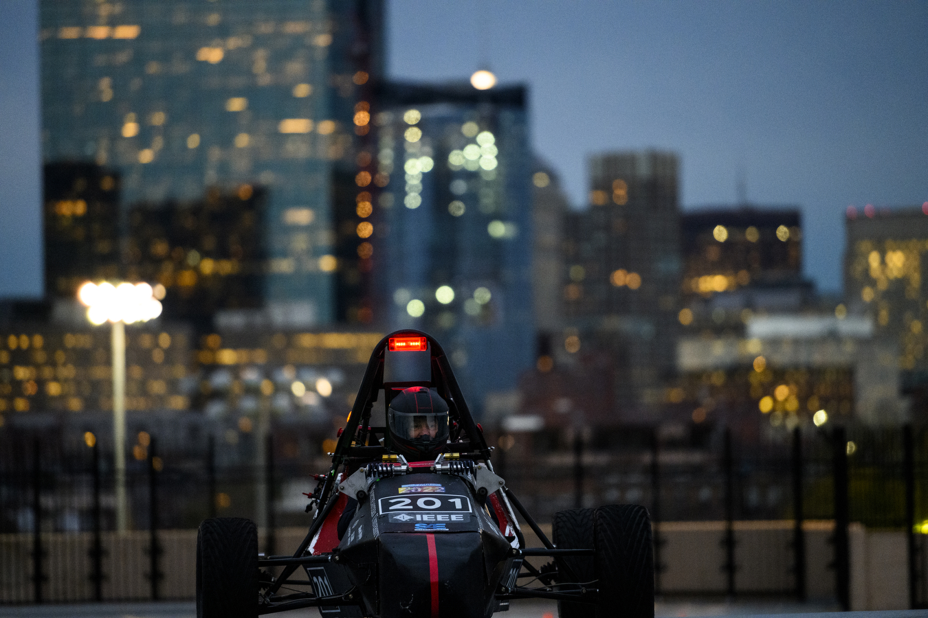 Electric car on top of parking garage at night