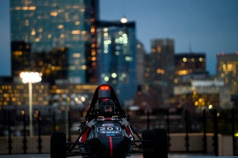 Electric car on top of parking garage at night