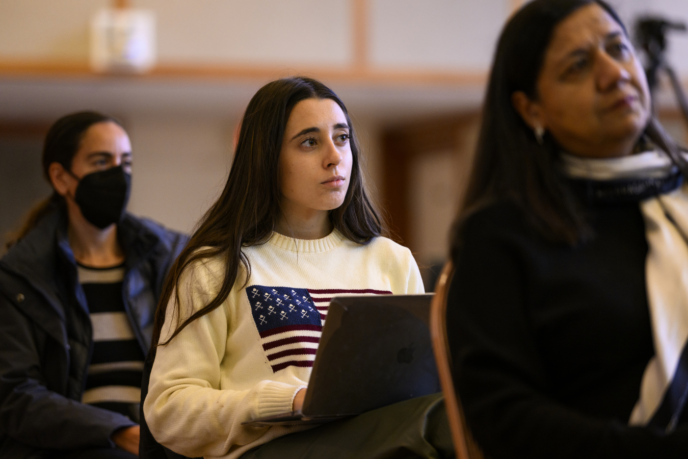 Northeastern student taking notes during panel discussion