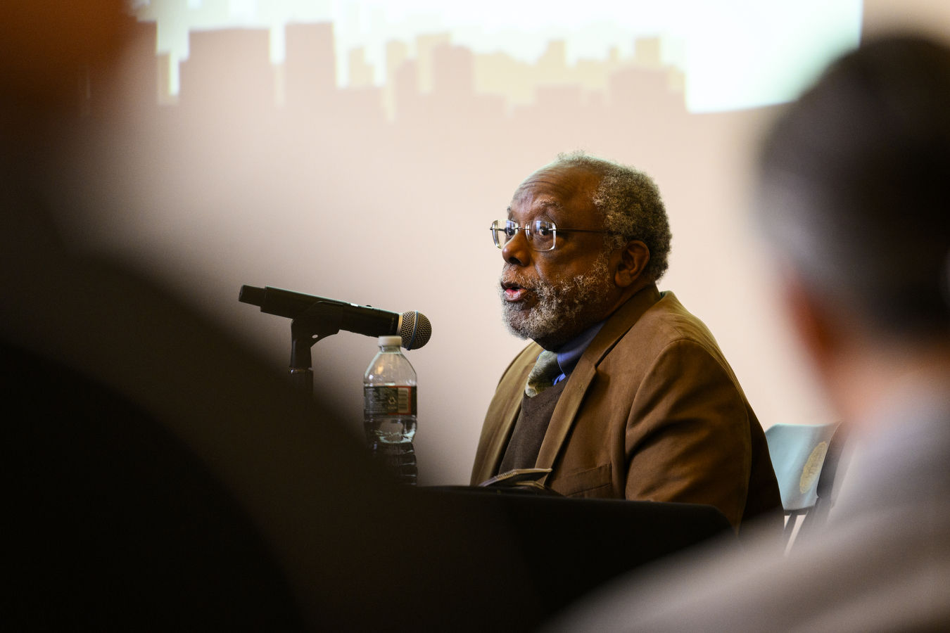 Ted Landsmark speaking into a microphone