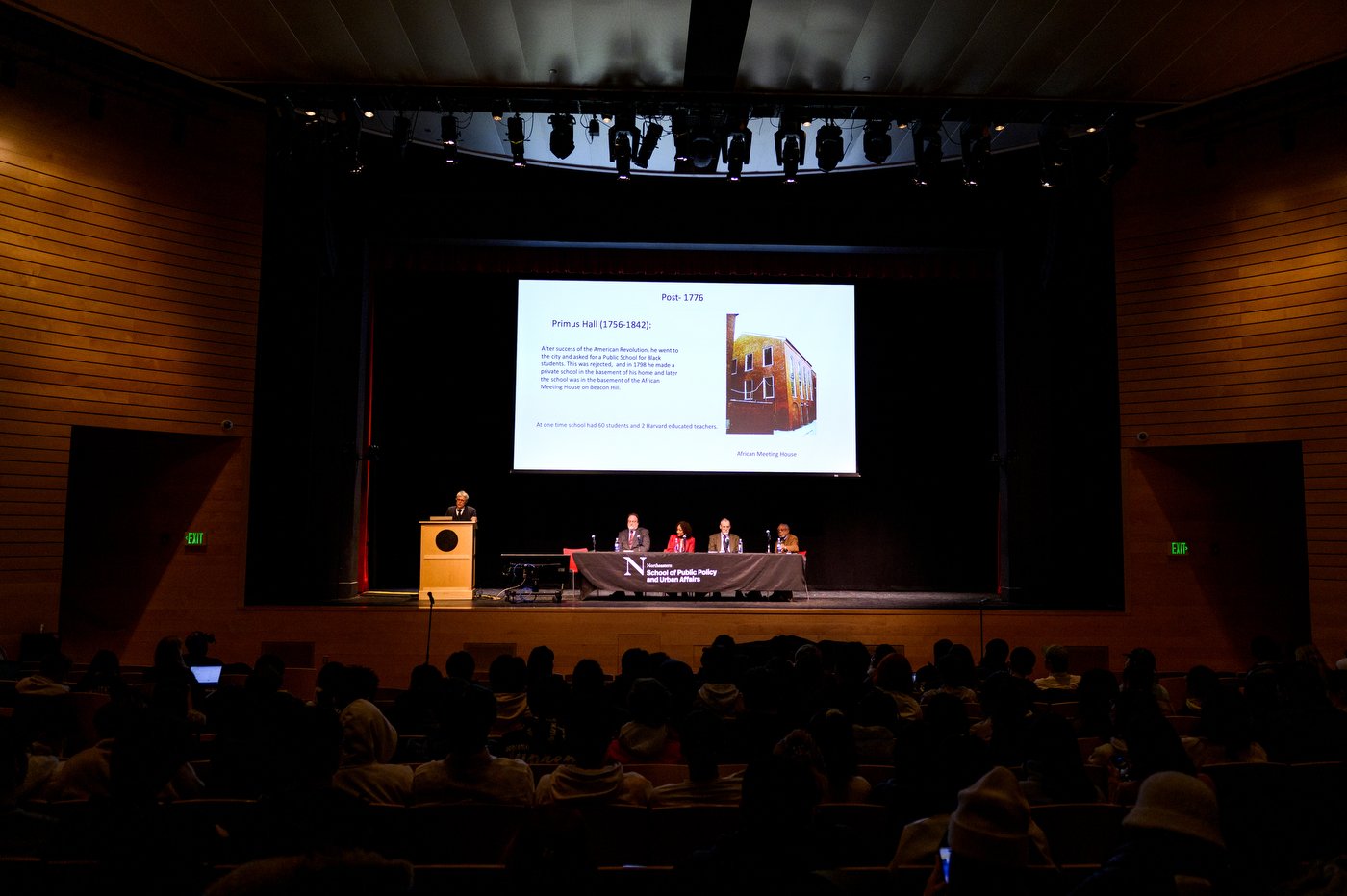 panel discussion on an auditorium stage