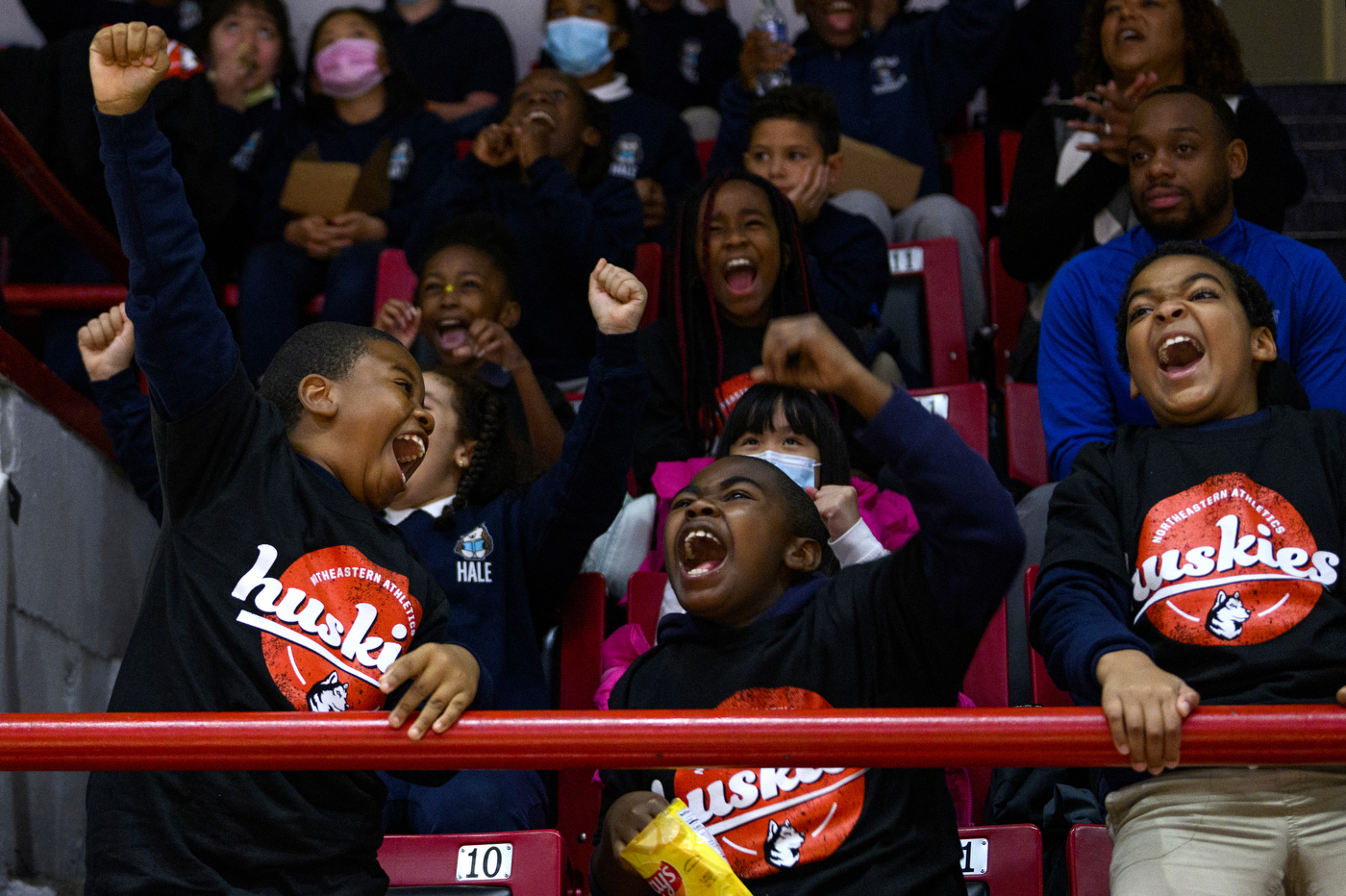 students cheering at basketball game