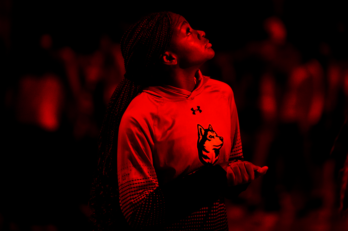 student looks up at basketball game