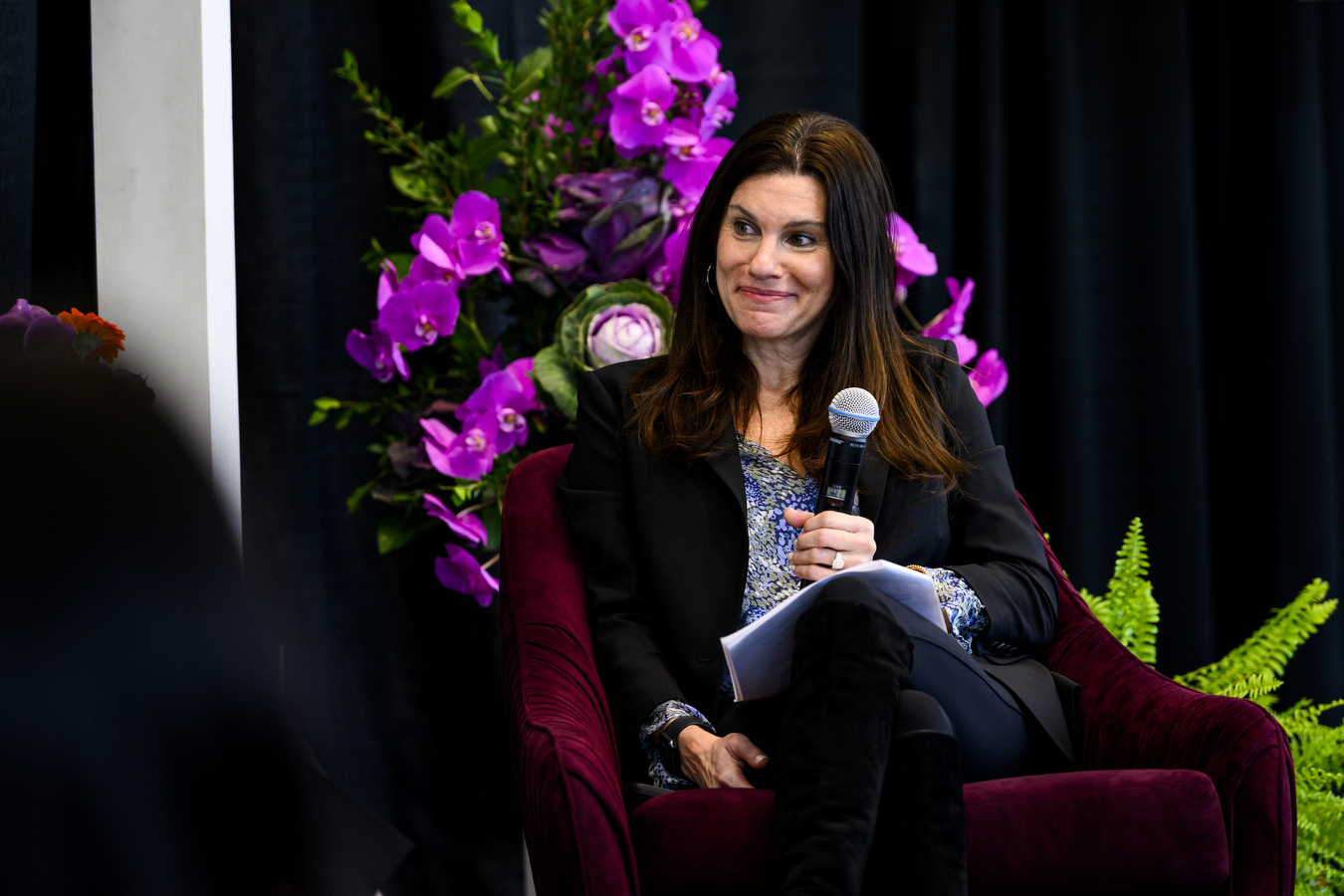 Woman holding mic at event