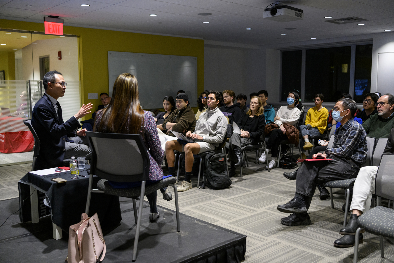 audience members listening to a panel discussion