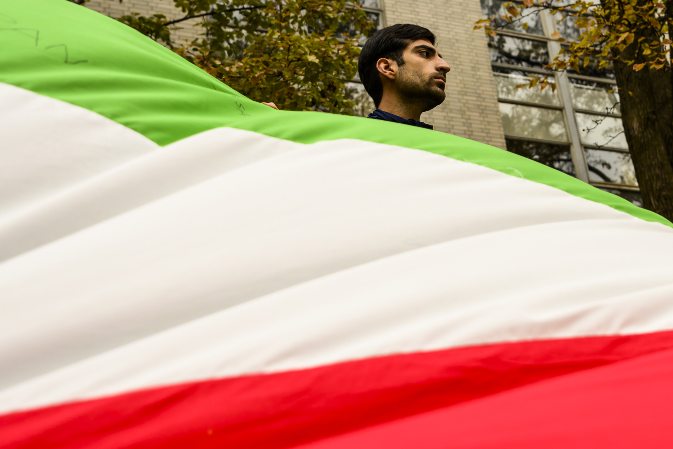 student holding Iranian flag