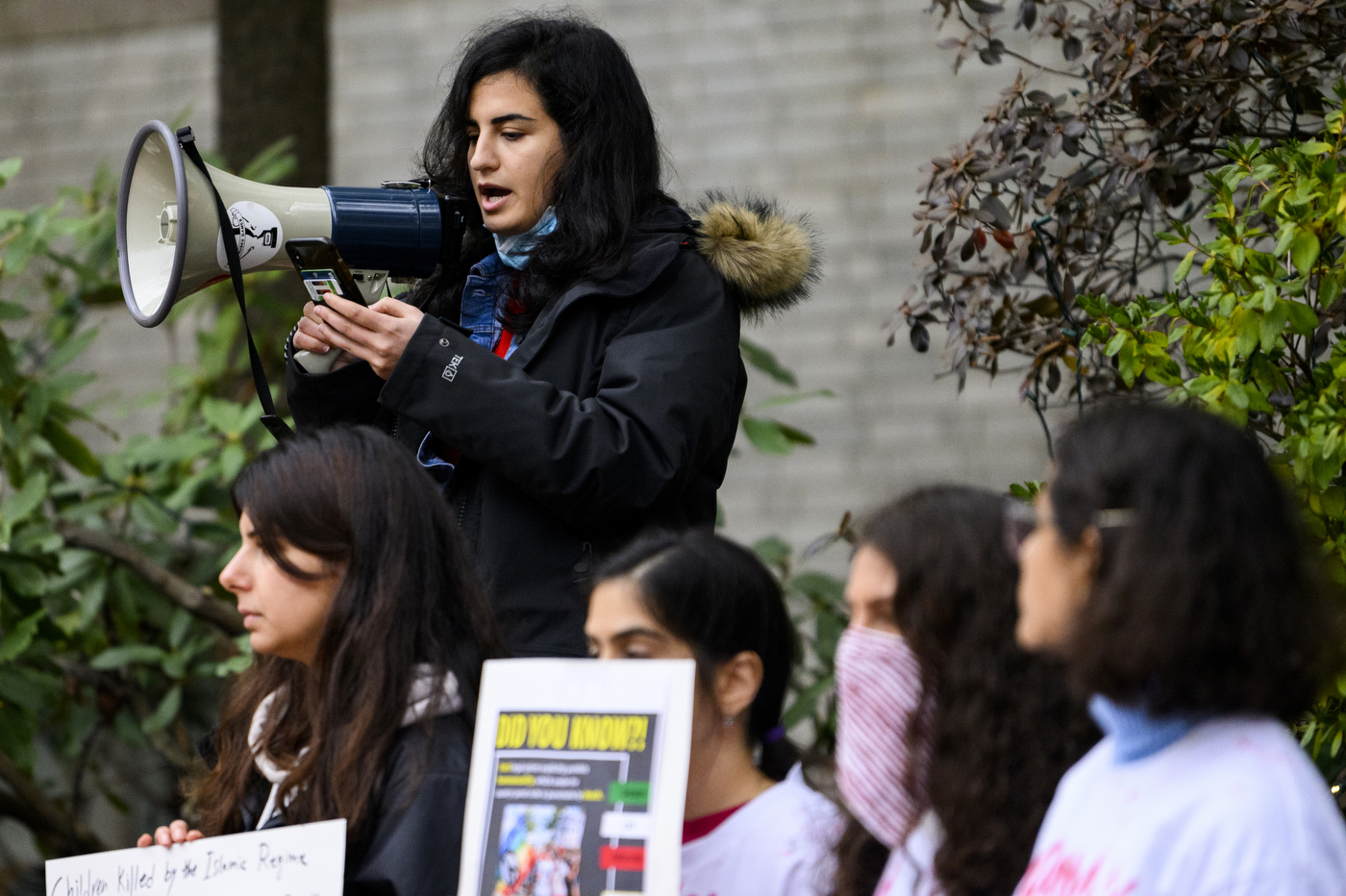 student speaking into megaphone at rally