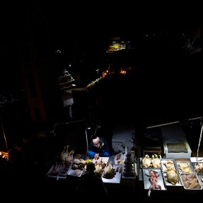 vendors in a market in the dark