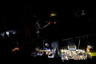 vendors in a market in the dark