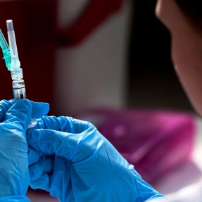 medical professional holding syringe