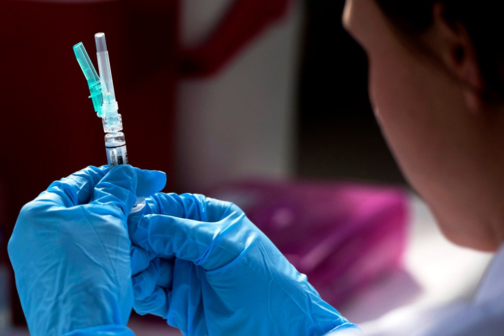 medical professional holding syringe